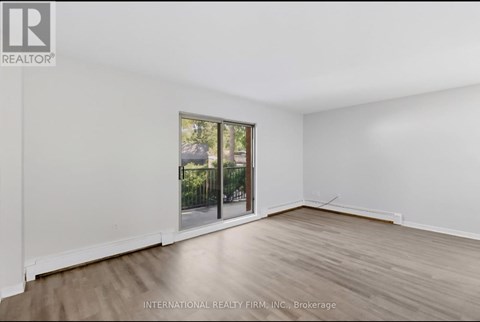 A room with a sliding glass door leading to a balcony.
