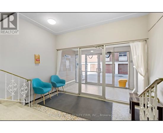 A room with a white wall and a glass door leading to a balcony.