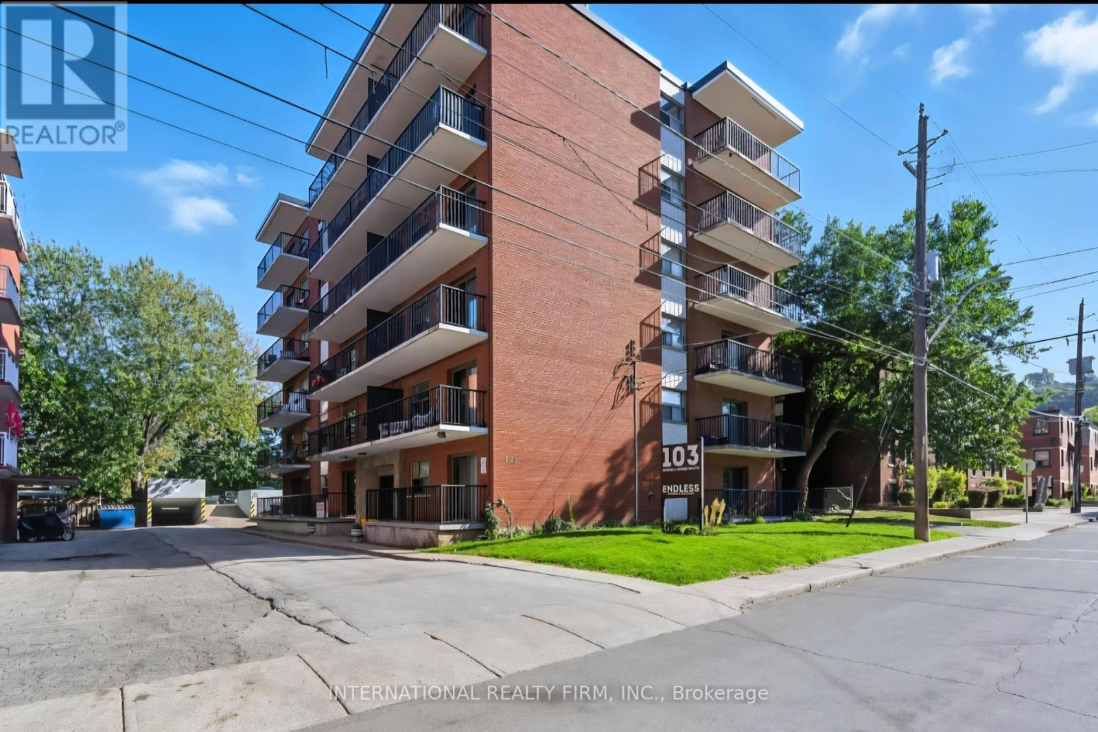 A tall apartment building with the number 103 on it.