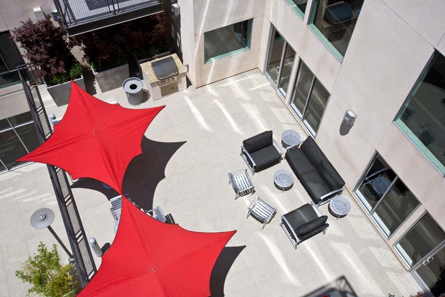 a red and black umbrella in the courtyard of a building