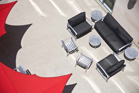 an aerial view of chairs and tables in a courtyard