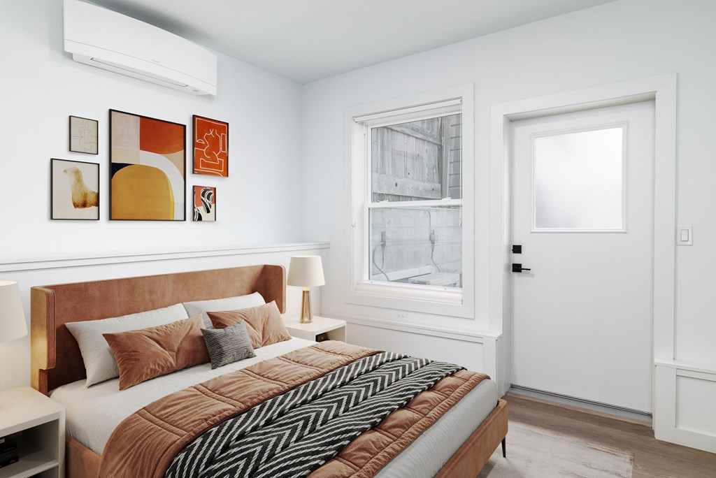 A bedroom with a large bed and a window.