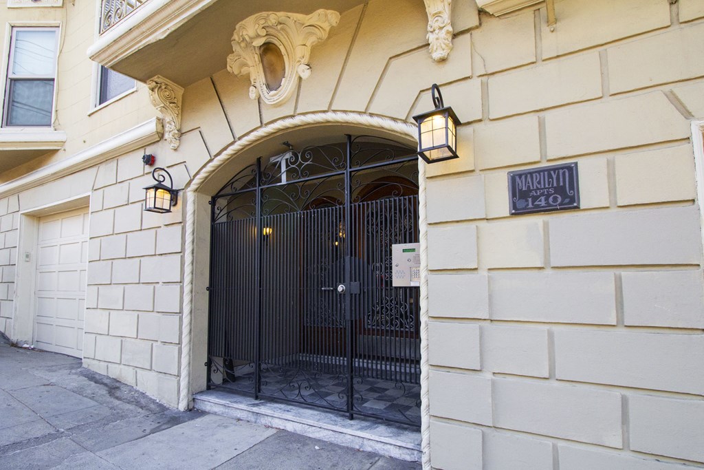 A building with a black gate and a sign that says "Marley 140".