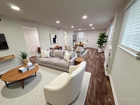 A modern living room with a wooden coffee table and a grey sofa.