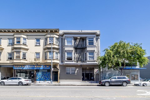 A building with a blue mural on the front and a sign that says "Golden Gate Glass Mirror Co."