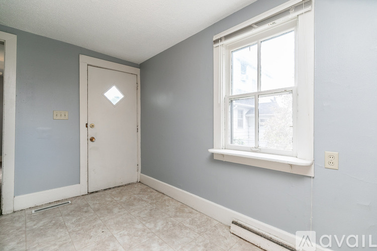 A room with a white door and a window with a white frame.