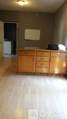 A wooden dresser with a white bag on top of it.