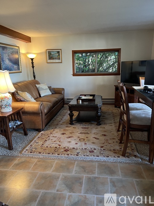 A living room with a couch, chair, and coffee table.