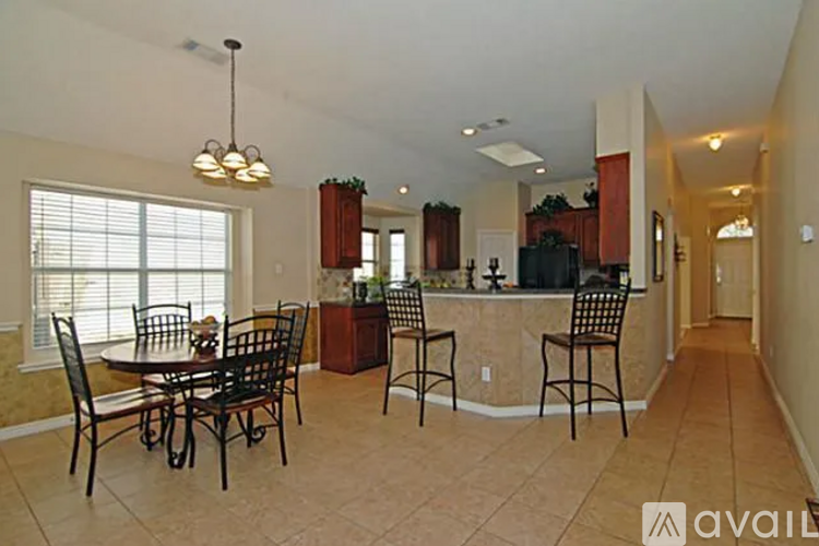 A dining room with a table set for four.