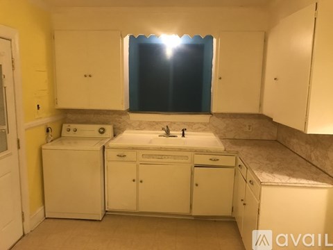A bathroom with a sink, mirror, and cabinets.
