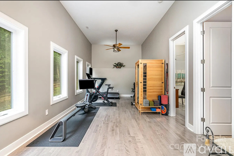 A room with a treadmill and exercise equipment.