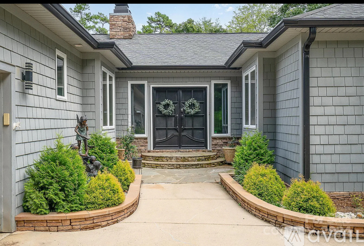 A house with a grey exterior and a black door.