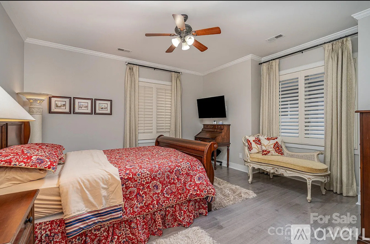 A bedroom with two beds and a bench is for sale.