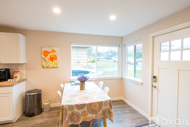 A dining room with a table set for four.