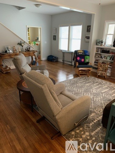 A living room with a sofa set and a rug.