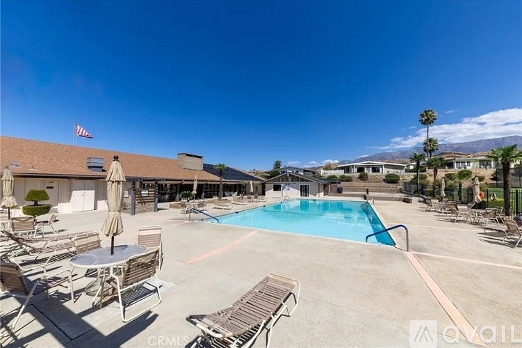 A pool area with chairs and a table is available for rent.