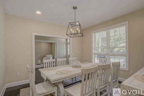 A dining room with a table set for four.