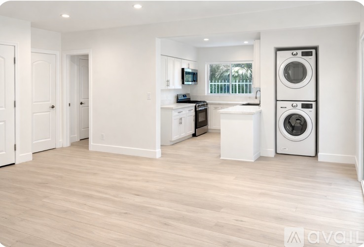 A white laundry room with a washer and dryer.