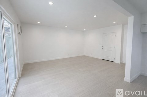 A spacious room with a door and a window.