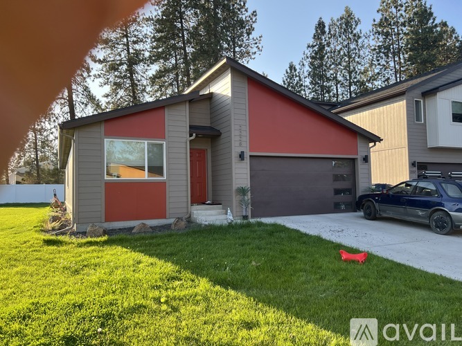 A house with a red garage door is for sale.