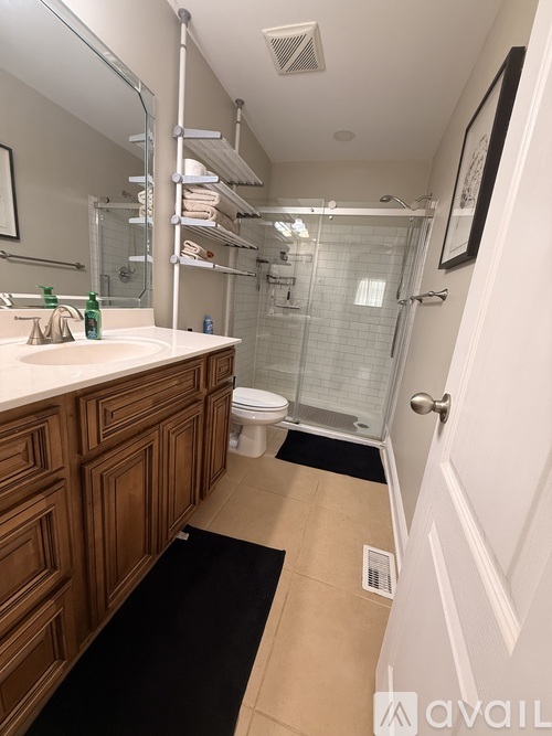 A bathroom with a sink, toilet, and shower.