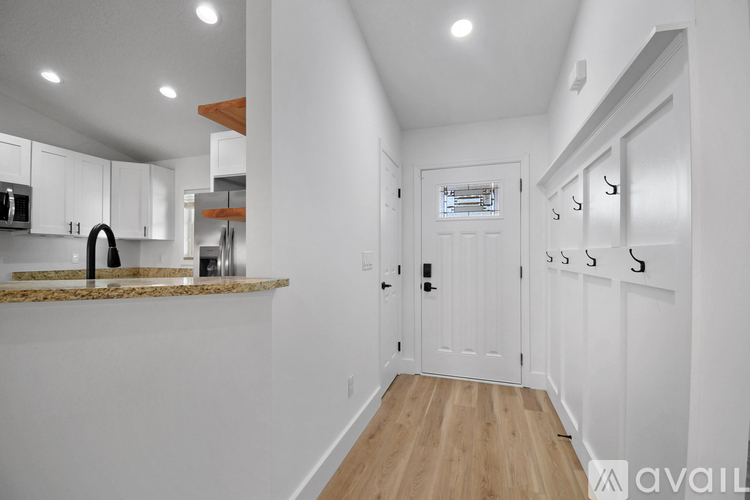 A kitchen with white cabinets and a granite countertop.