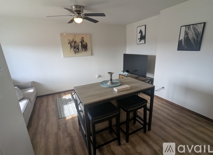 A living room with a television, a table, and a couch.