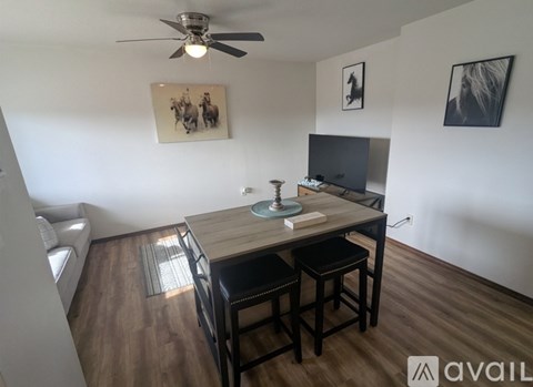 A living room with a television, a table, and a couch.