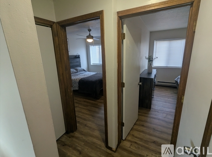 A room with a bed and a desk is visible through a mirror.