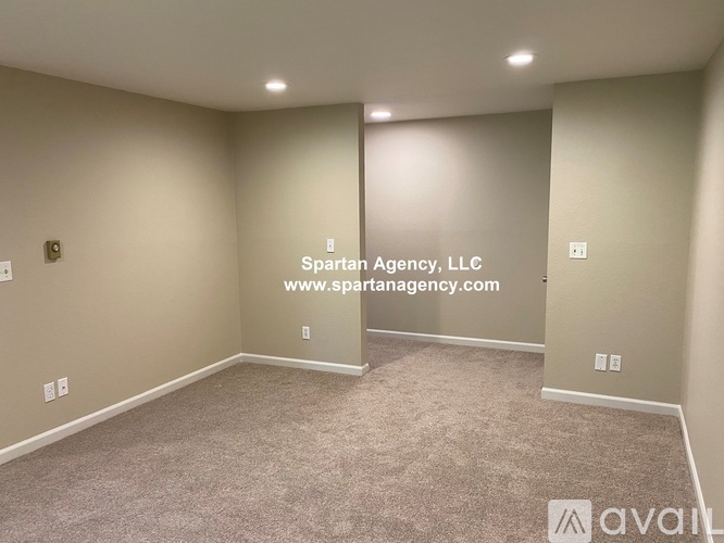A room with Spartan Agency, LLC logo and website on the wall.