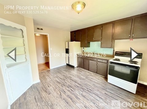 A kitchen with a white oven and brown cabinets.