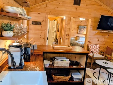 A kitchen with wooden walls and a window.