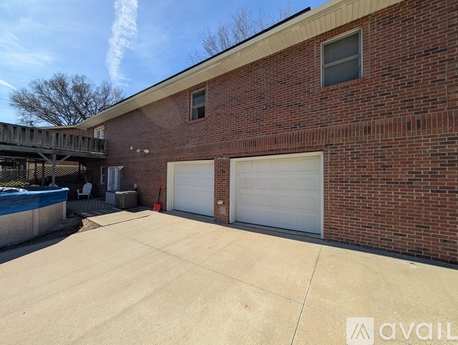 A red brick building with a white garage door.
