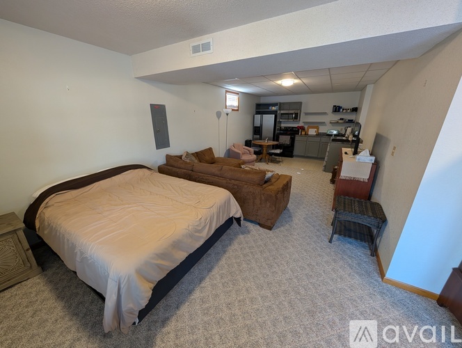 A bedroom with a bed and a couch in it.