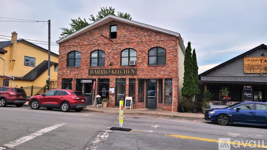 A brick building with a sign that says Barrio Kitchen.