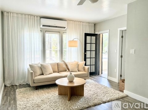 A living room with a white couch and a coffee table.