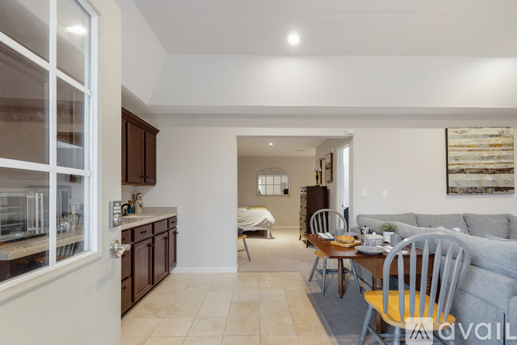 A kitchen with a table and chairs in the middle of the room.