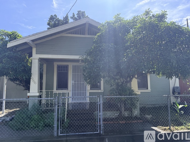 A house with a fence and a sign that says "available" in front of it.