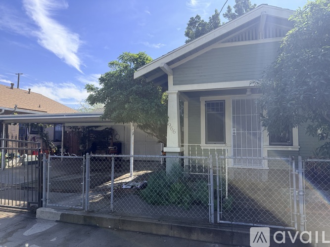 A house with a fence in front of it is for sale.