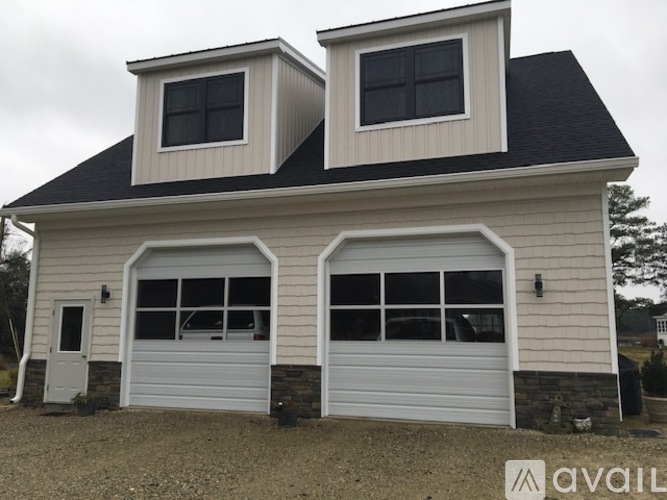 A two-car garage with a white door and windows is available for rent.