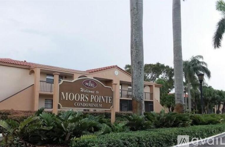 A sign welcoming people to Moors Pointe Condominiums.