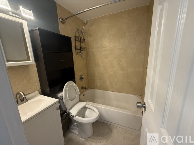 A bathroom with a toilet, sink, and bathtub.