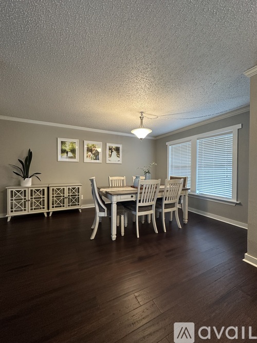 A dining room with a table set for four.