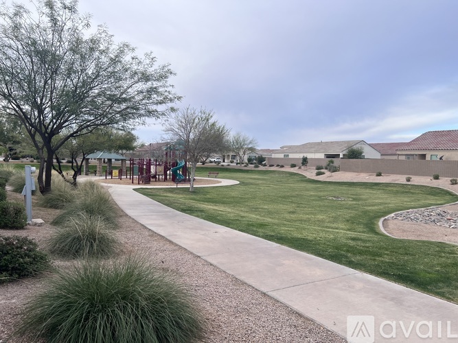 A park with a playground and a walking path.