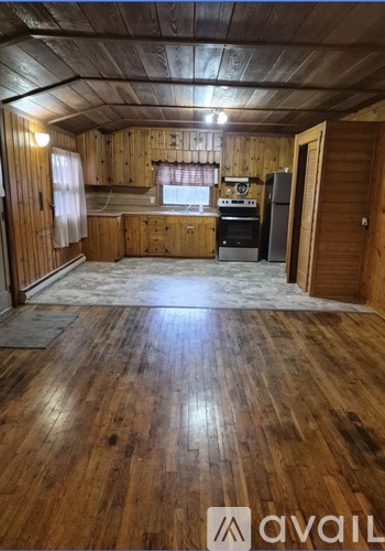 A wooden room with a window and a door.