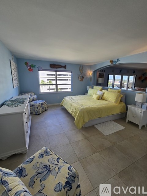 A bedroom with a yellow bed and a white dresser.