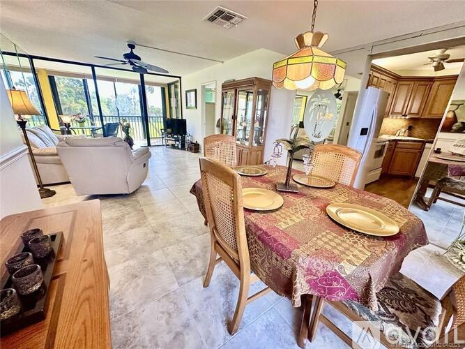 A dining room with a table set for four.