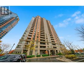 A tall residential building with a Real Broker Ontario Ltd. sign in front.