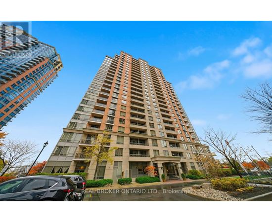 A tall residential building with a Real Broker Ontario Ltd. sign in front.