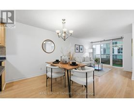 A dining room with a wooden table and chairs.